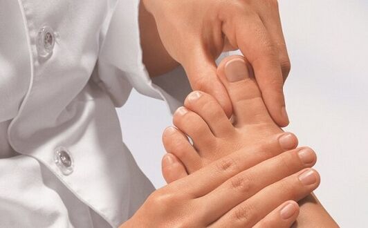 Expert checks feet for fungal infection